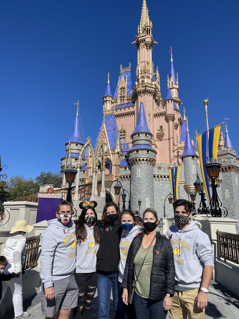Group photo in front of Cinderella castle during Disney VIP tour