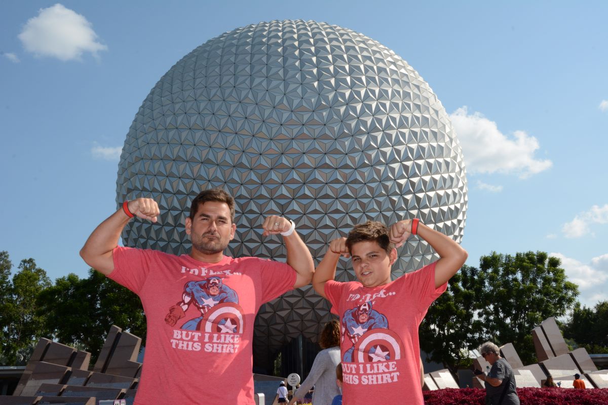father and son standing in front of epcot